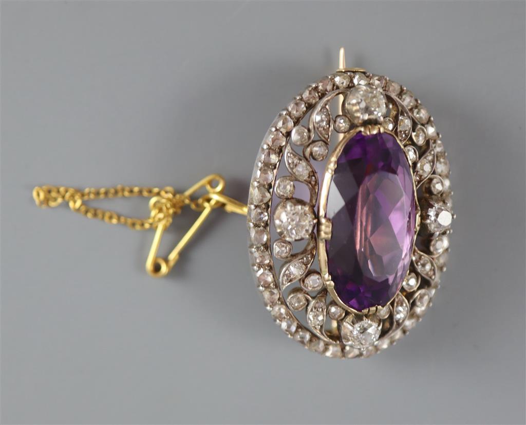 A Victorian gold and silver, diamond and amethyst set oval brooch, with safety chain,